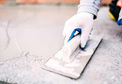 A Plastering Contractor in Peoria IL applying plaster to a surface