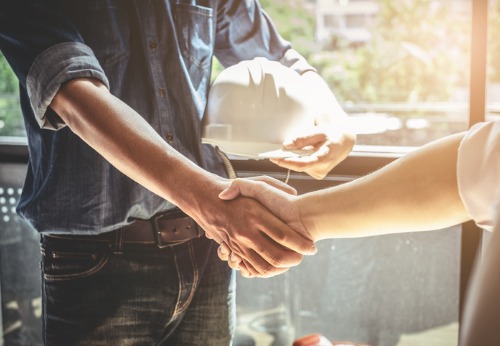 A Commercial Contractor in Peoria IL shaking hands with a client