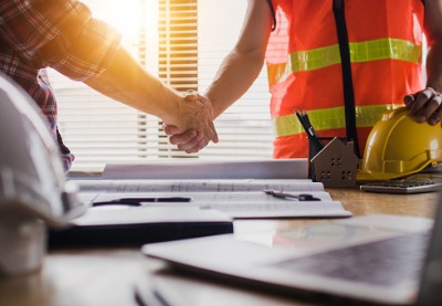 Commercial Contractors in Peoria IL shaking hands with a project manager